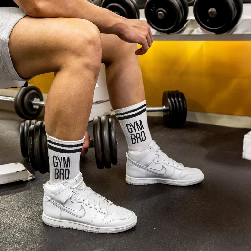 Paio di calze bianche sportive decorate con scritta “Gym bro”