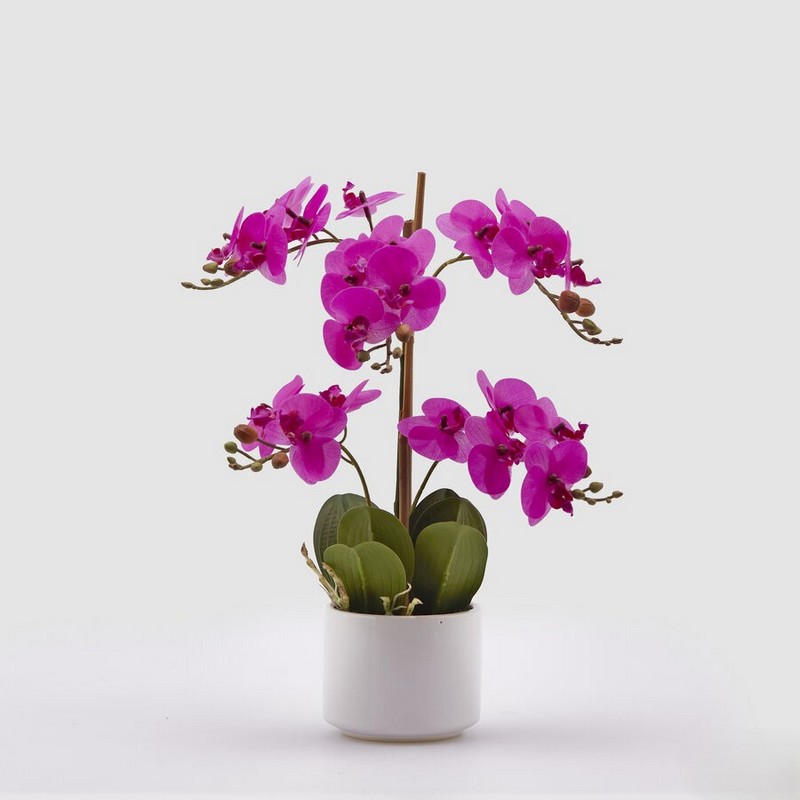 Orchidea fucsia artificiale in vaso, realistica al tatto, con terriccio e foglie