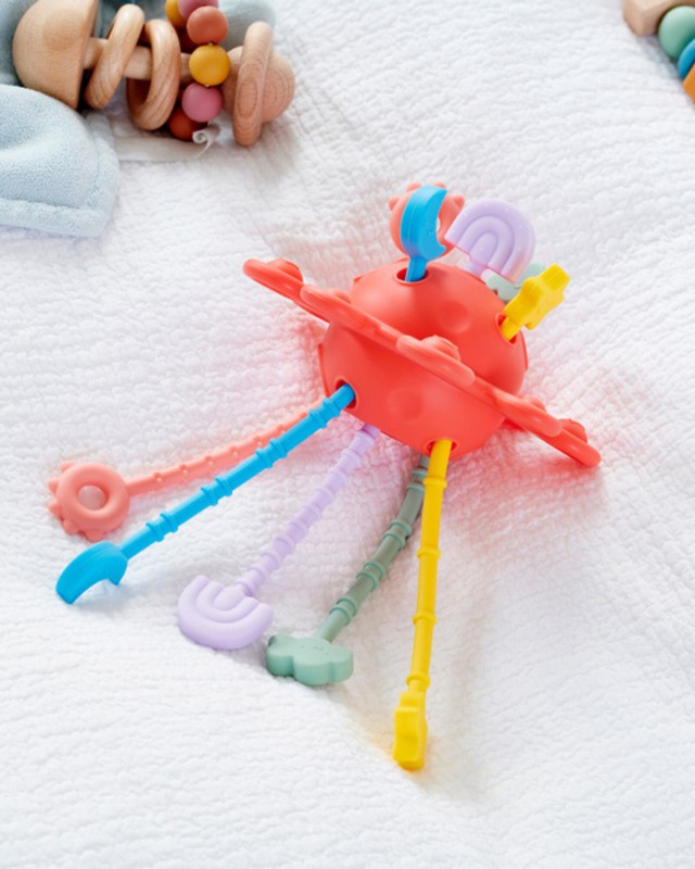 Gioco multisensoriale tattile a forma di pianeta rosso per bambini con appendici rigate e pulsanti