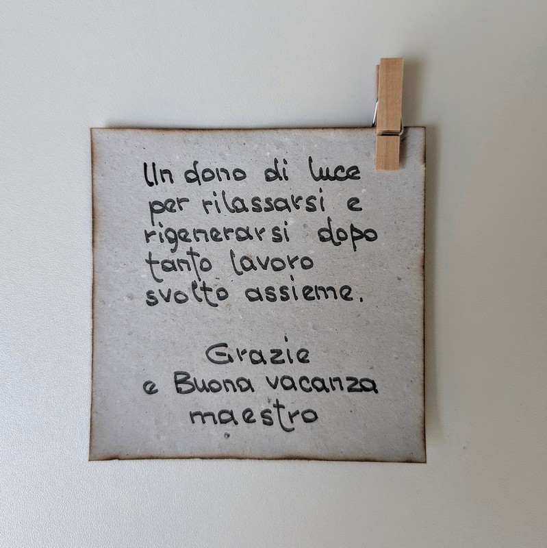 Biglietto per maestro con dedica: “Un dono di luce per rilassarsi e rigenerarsi dopo tanto lavoro svolto insieme. Grazie e buona vacanza maestro”, perfetto da abbinare ai regali per i maestri a fine anno scolastico