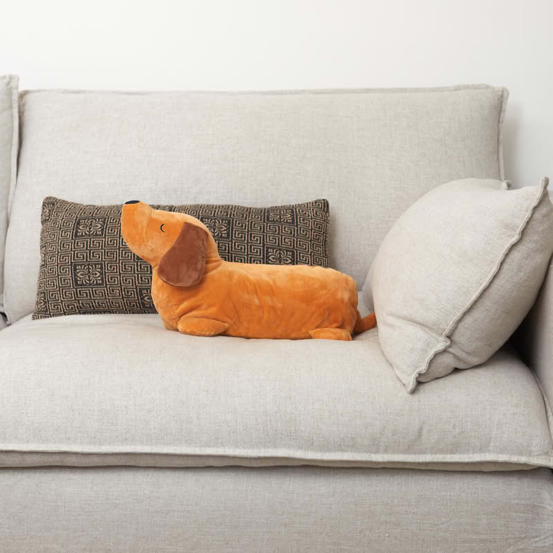 Cuscino a forma di bassotto marrone con al suo interno una coperta dello stesso colore di dimensione 150 x 110 cm, il tutto è lavabile in lavatrice